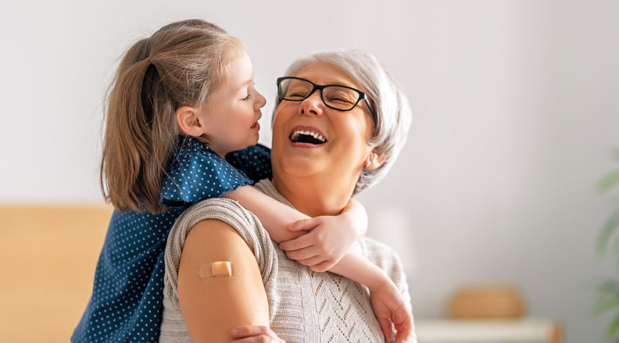 senior-woman-after-vaccination senior woman with grandchild
