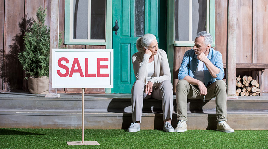 upset-senior-couple-sitting-on-porch-and-selling-t-SCDW498 upset-senior-couple-sitting-on-porch-and-selling