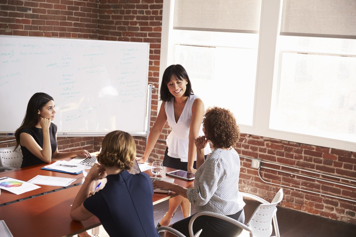 Group Of Businesswomen Meeting In Modern Boardroom